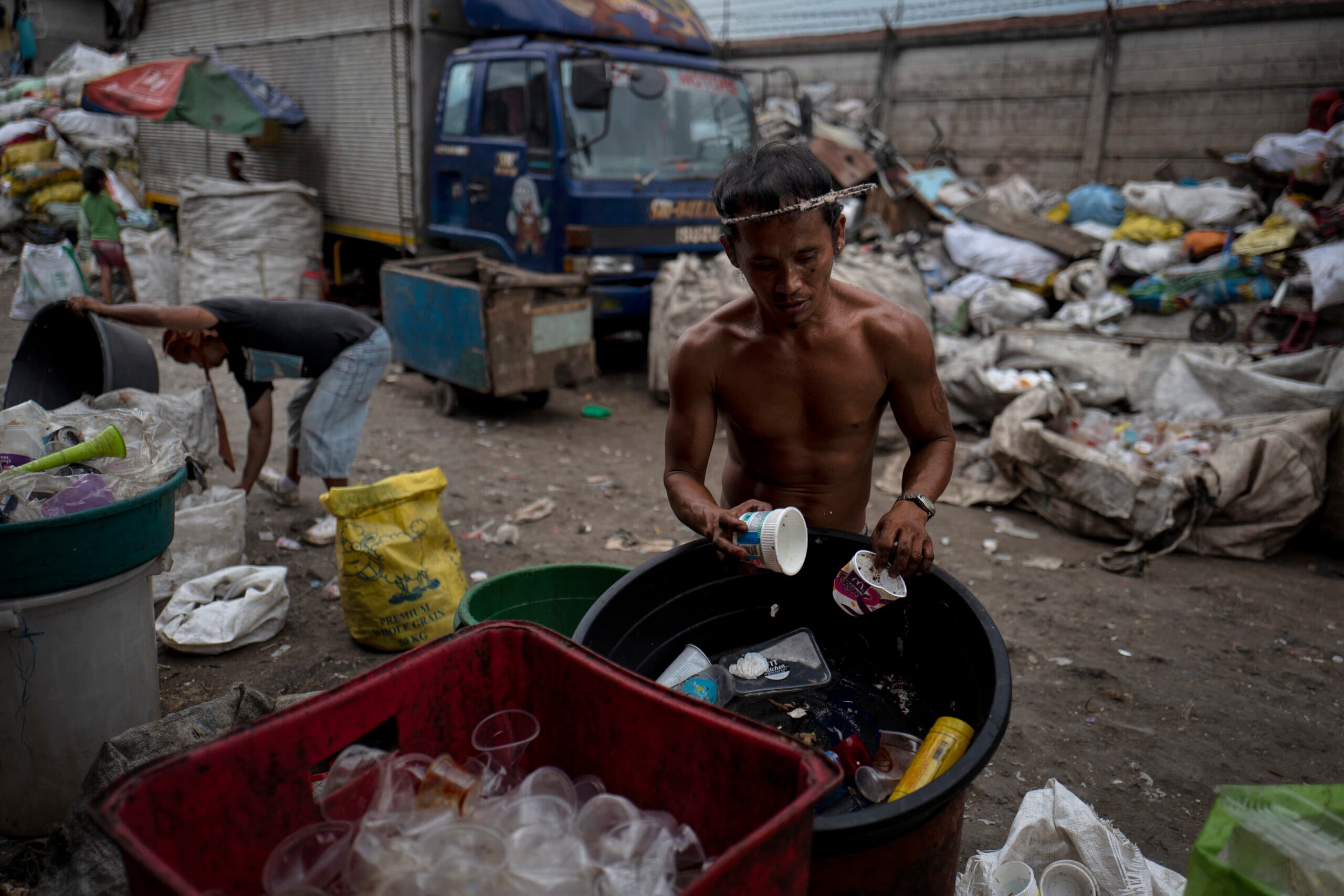 MANILA, PHILIPPINES - APRIL 18: Residents of Happy Land village collects and recycle plastic wastes ...