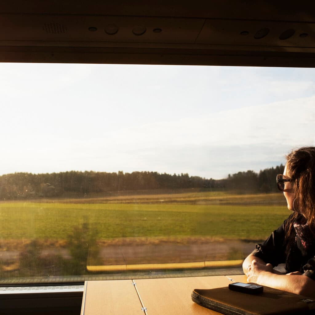 scandinavia, sweden, color image, commute, commuter, copy space, day, head and shoulders, horizontal, journey, landscape, leisure, lifestyle, look out, mid adult, one mid adult woman only, one person only, passenger, photography, relaxing, ride, side view, train, vehicle interior, window, tågfönster, tåg, tågresa, resa, kvinna på tåg,