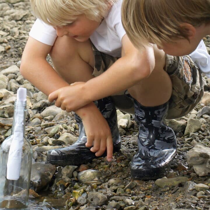 hampshire, 6-7 years, adventure, blonde hair, bottle, boy, brother, carefree, caucasian, childhood, color image, communication, concentration, concept, cooperation, countryside, crouching, curiosity, day, discovery, edge, elementary age, enjoying, environment, examining, exploring, friend, full length, fun, innocence, inspecting, looking down, message, message in a bottle, nature, note, only boys, outdoors, paperwork, people, photography, preschooler, remote, rural scene, scrutiny, side view, stream, teamwork, together, travel, two people, united kingdom, vacation, vertical, wading, weekend activities, wonder, working together, 2-3 years