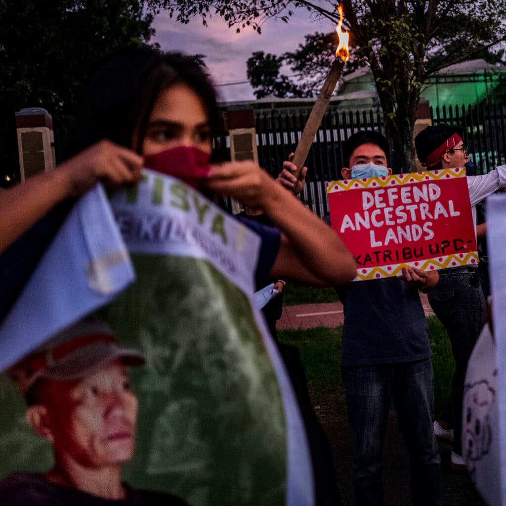 MANILA, PHILIPPINES - NOVEMBER 10: Activists hold up torches and portraits of slain indigenous peoples and environmental defenders during a rally on November 10, 2022 in Quezon city, Metro Manila, Philippines. As world leaders convene for the 27th United Nations Climate Change Conference of the Parties (COP27) in Egypt, the Philippines continues to be among those in the top list of the most murderous countries for indigenous peoples and environment defenders. Groups and individuals opposing damaging industries and corporate forest and natural resources destruction are often met with violent crackdowns from the police and military. International non-profit Global Witness has recorded incidents in relation to defenders’ opposition to mining, logging, and dam projects. (Photo by Ezra Acayan/Getty Images)