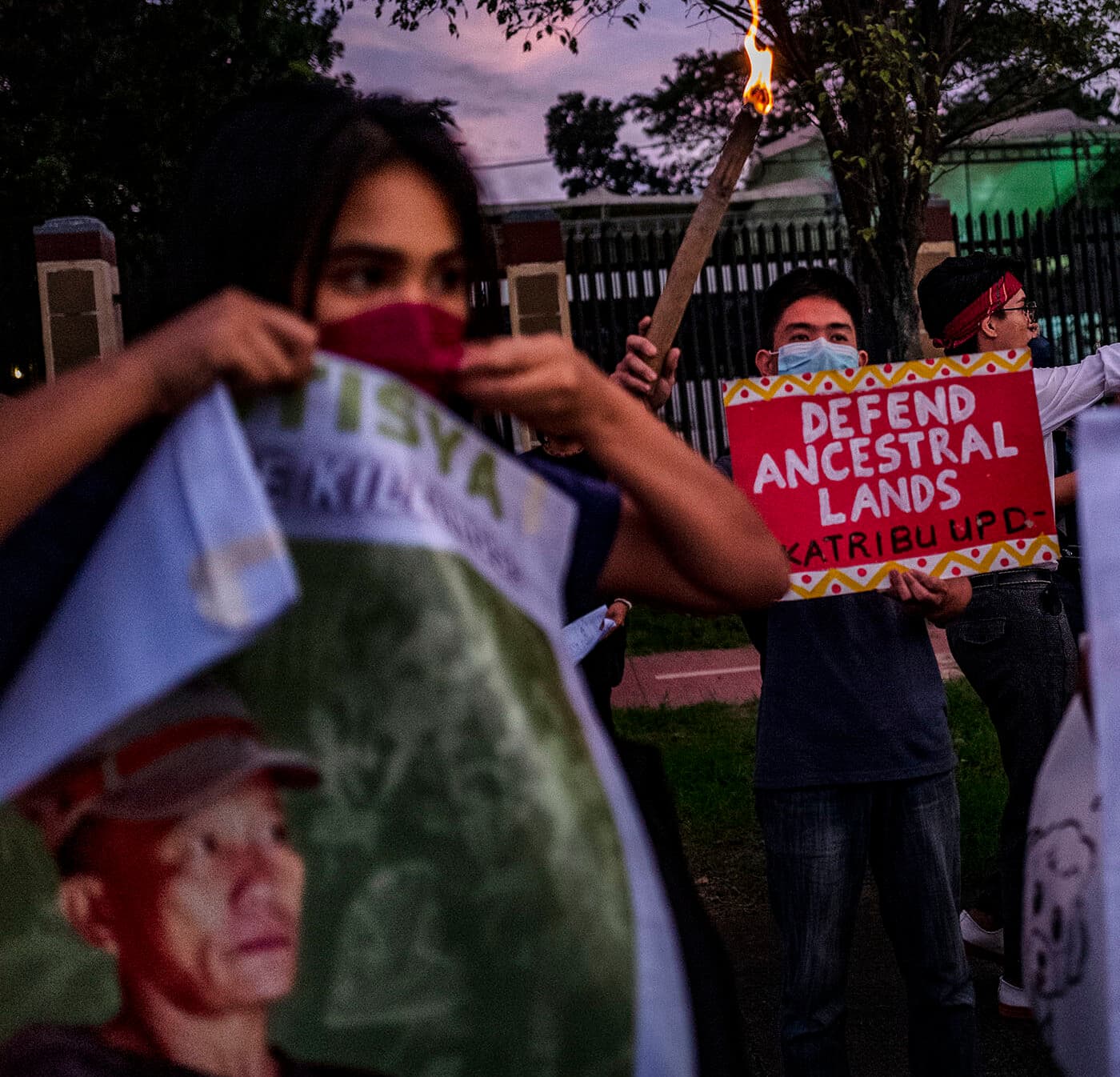 MANILA, PHILIPPINES - NOVEMBER 10: Activists hold up torches and portraits of slain indigenous peoples and environmental defenders during a rally on November 10, 2022 in Quezon city, Metro Manila, Philippines. As world leaders convene for the 27th United Nations Climate Change Conference of the Parties (COP27) in Egypt, the Philippines continues to be among those in the top list of the most murderous countries for indigenous peoples and environment defenders. Groups and individuals opposing damaging industries and corporate forest and natural resources destruction are often met with violent crackdowns from the police and military. International non-profit Global Witness has recorded incidents in relation to defenders’ opposition to mining, logging, and dam projects. (Photo by Ezra Acayan/Getty Images)