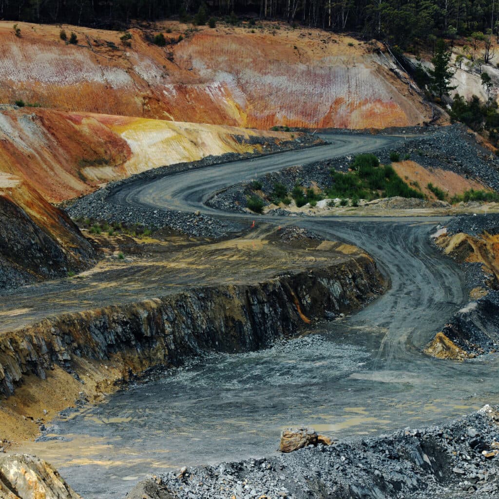 A road runs through an open pit mine at a site in Greenbushes, Australia. Photographer: Carla ...